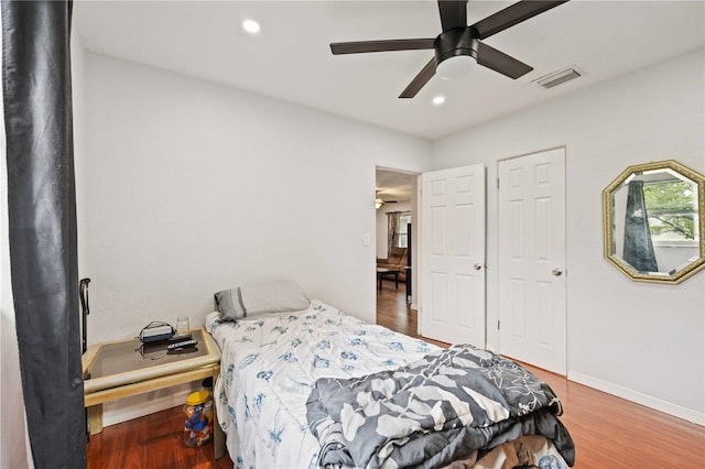 bedroom with ceiling fan and wood-type flooring