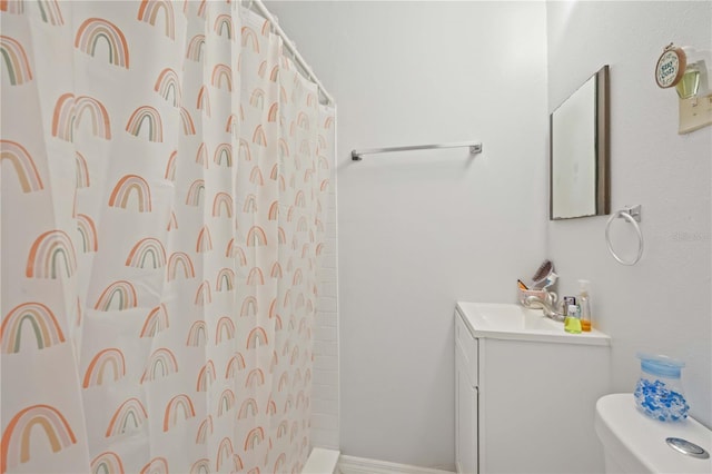 bathroom featuring vanity, toilet, and a shower with curtain