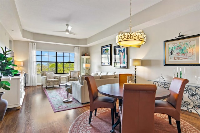 dining room with wood finished floors and a ceiling fan