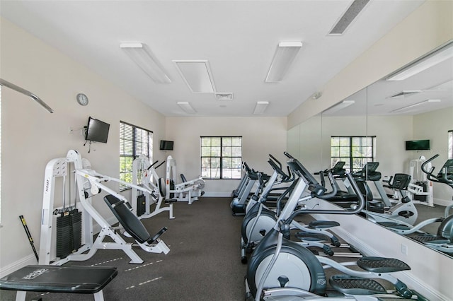 exercise room featuring visible vents and baseboards
