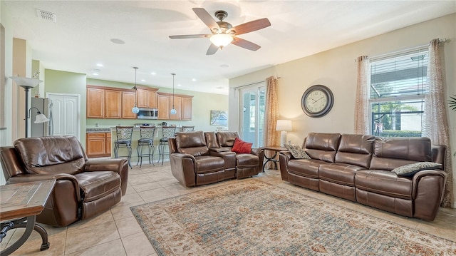 tiled living room with ceiling fan