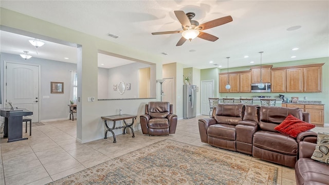 tiled living room with ceiling fan