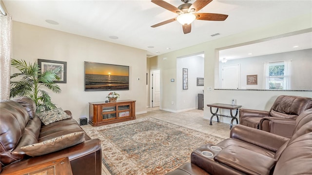 living room featuring ceiling fan and light tile patterned flooring