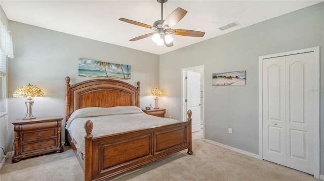 carpeted bedroom featuring ceiling fan and a closet