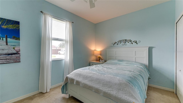 carpeted bedroom featuring multiple windows, ceiling fan, and a closet