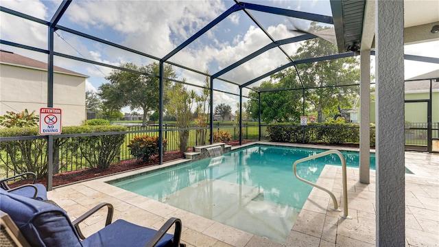 view of swimming pool with a lanai and a patio area