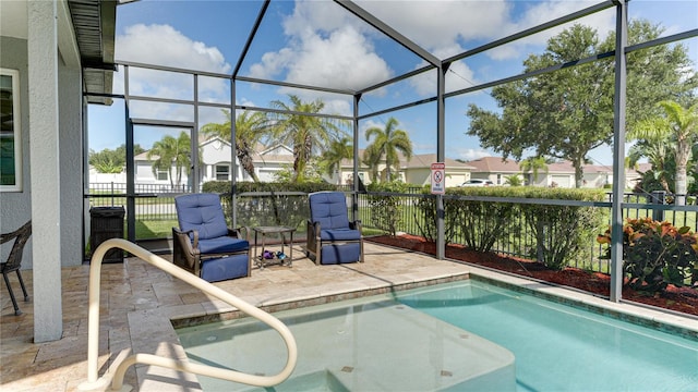 view of swimming pool with a lanai and a patio