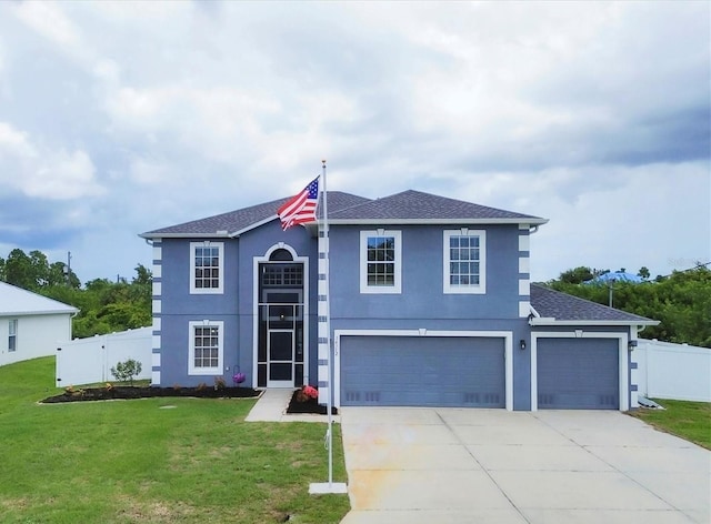 view of front of house featuring driveway, fence, a front lawn, and stucco siding