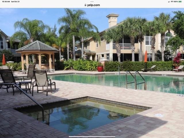 view of swimming pool with a patio and a gazebo