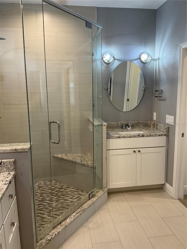 full bath featuring a stall shower and vanity