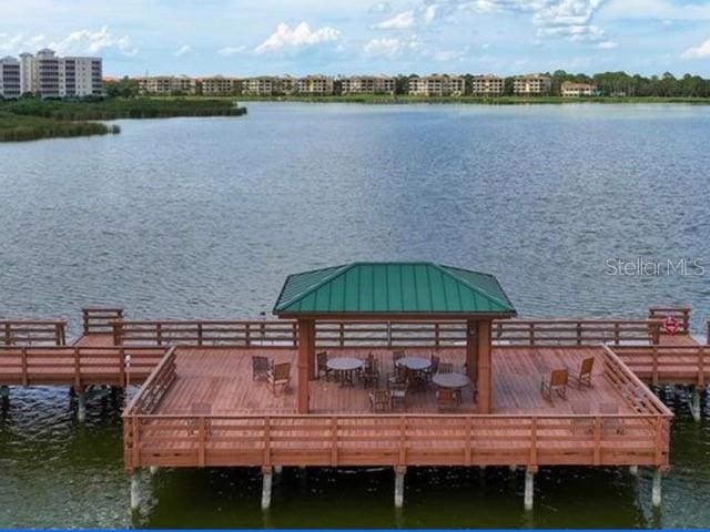 dock area featuring a deck with water view and a gazebo