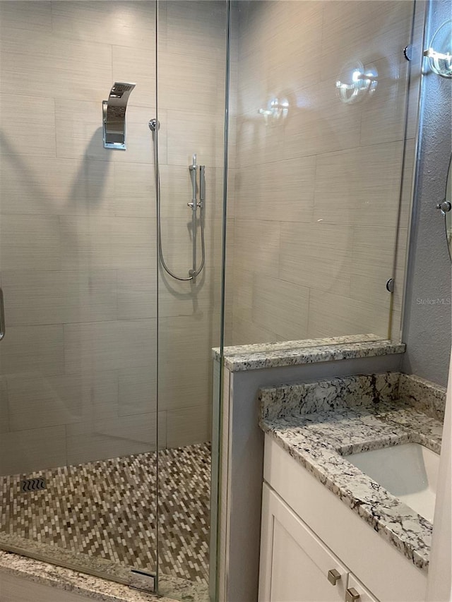 full bathroom featuring a shower stall and vanity