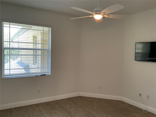 spare room with ceiling fan, baseboards, and wood finished floors