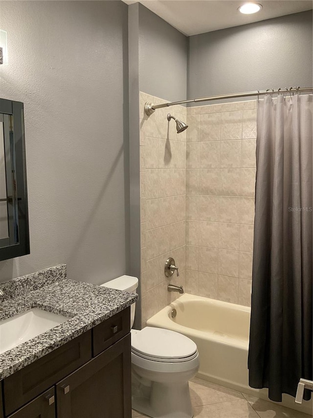 full bathroom with tile patterned floors, shower / bath combination with curtain, toilet, and vanity