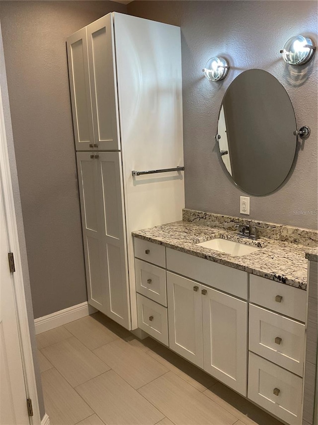 bathroom featuring vanity and baseboards