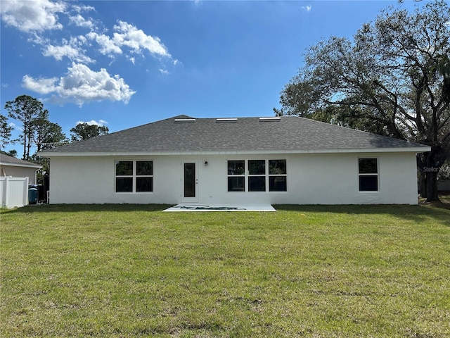 rear view of property featuring a yard