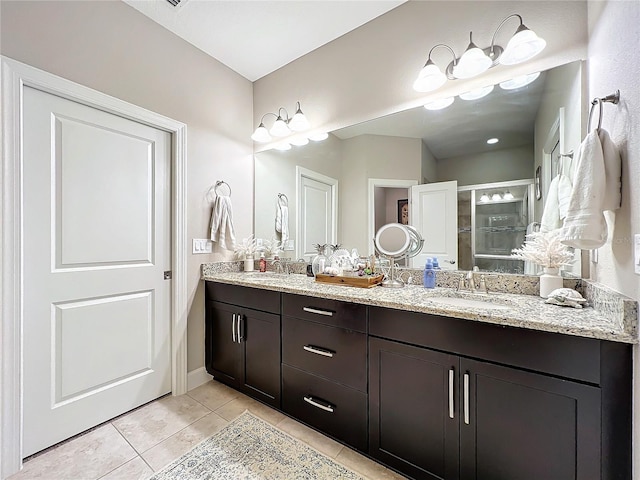 bathroom featuring vanity, walk in shower, and tile patterned flooring