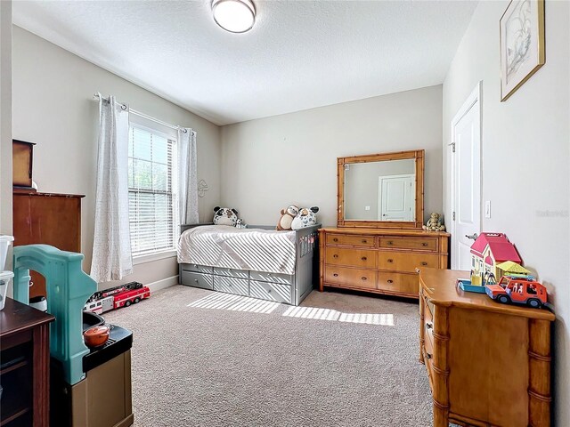 carpeted bedroom featuring a textured ceiling