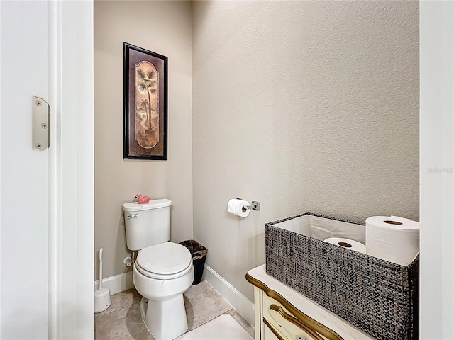 bathroom featuring tile patterned floors, toilet, and vanity