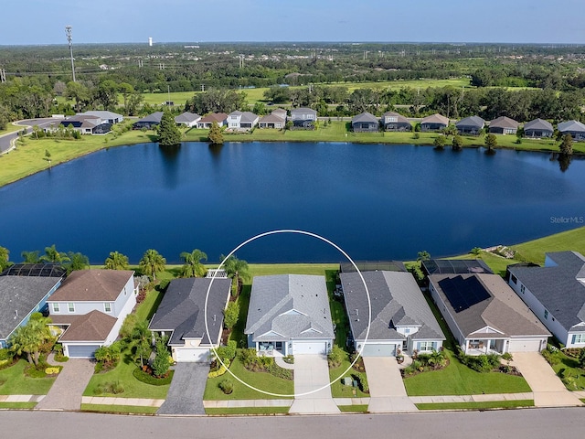 birds eye view of property with a water view