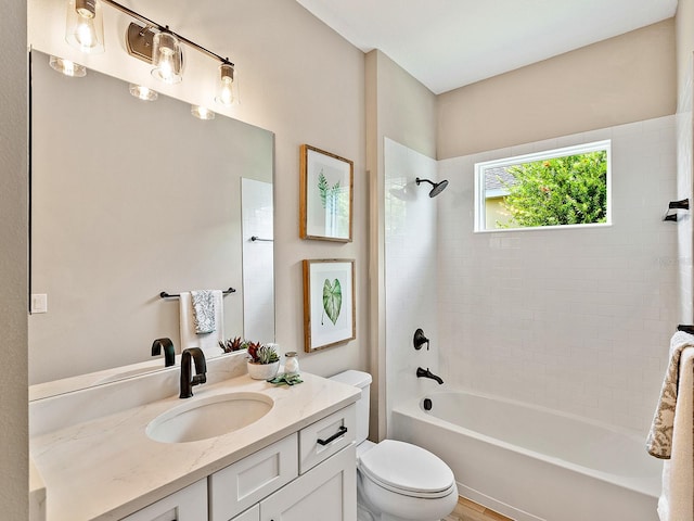 full bathroom featuring vanity, toilet, and tiled shower / bath combo