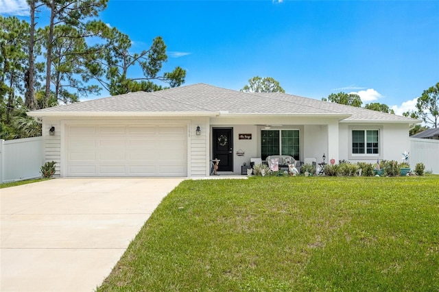 single story home with a garage and a front lawn