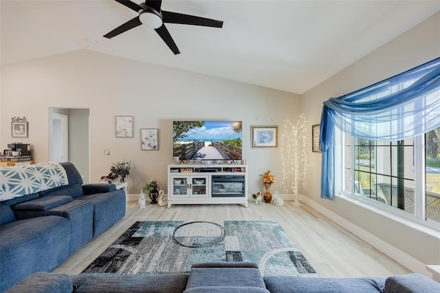 living room featuring lofted ceiling, ceiling fan, and light hardwood / wood-style flooring