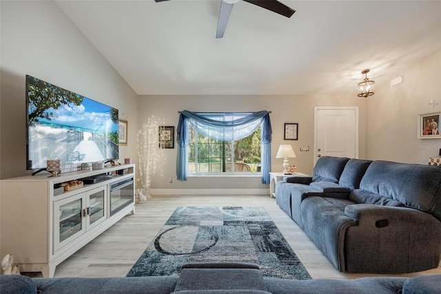 living room featuring light wood-type flooring, lofted ceiling, and ceiling fan