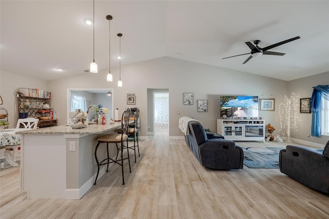 interior space with lofted ceiling, ceiling fan, and light hardwood / wood-style floors