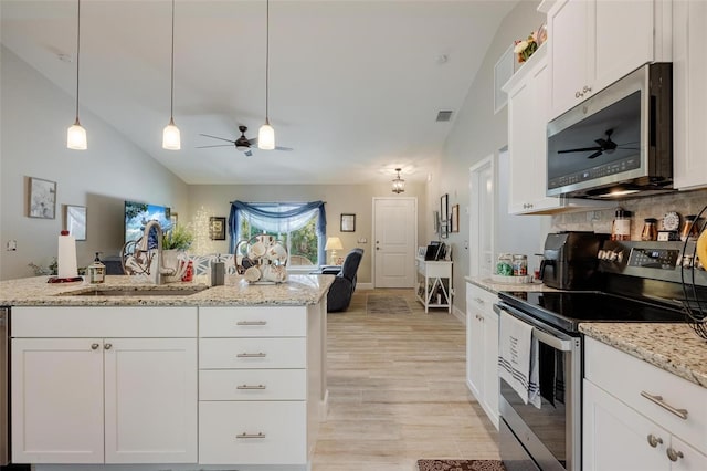 kitchen with appliances with stainless steel finishes, sink, white cabinetry, ceiling fan, and light wood-type flooring