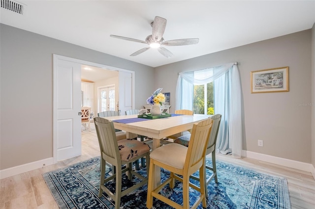 dining area with a healthy amount of sunlight, light hardwood / wood-style flooring, and ceiling fan