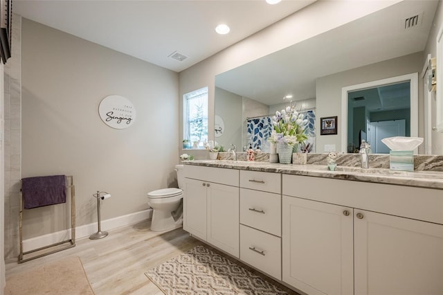 bathroom with curtained shower, toilet, hardwood / wood-style flooring, and vanity