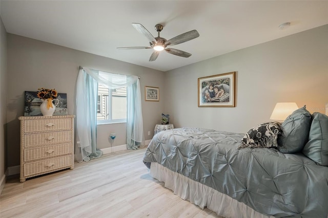 bedroom with light wood-type flooring and ceiling fan