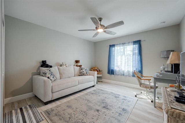 home office with light hardwood / wood-style flooring and ceiling fan