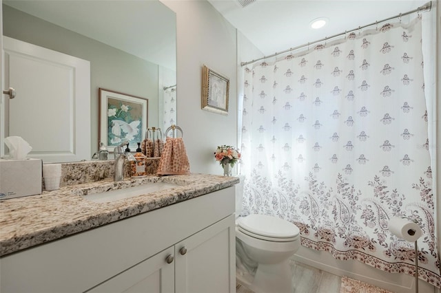 full bathroom featuring vanity, toilet, and shower / bath combo with shower curtain