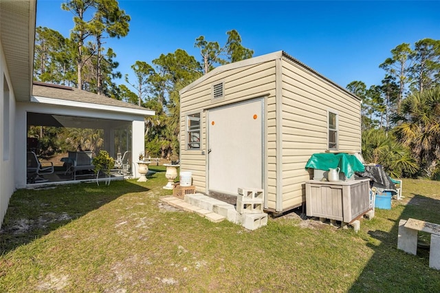 view of outbuilding featuring a lawn