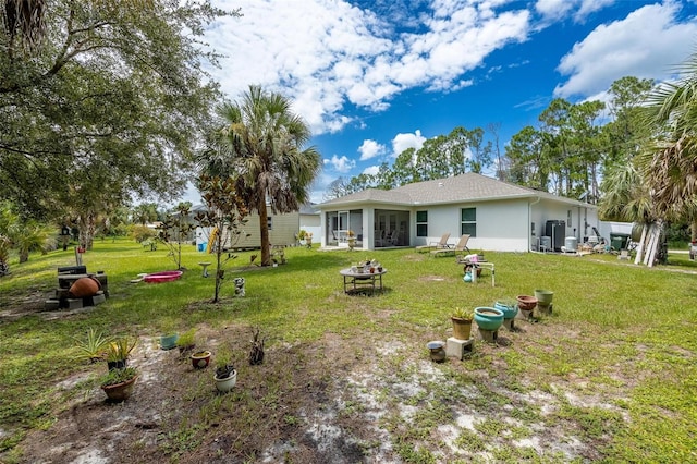 rear view of house with a lawn