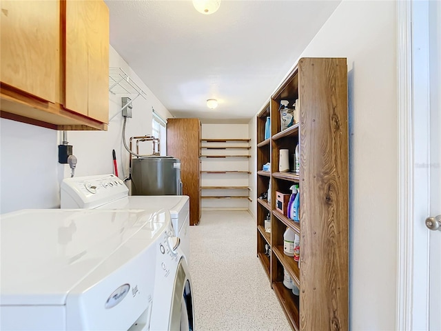 laundry room featuring independent washer and dryer, cabinets, and water heater