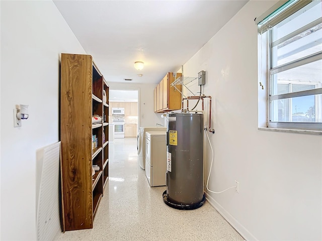 utility room with independent washer and dryer and water heater