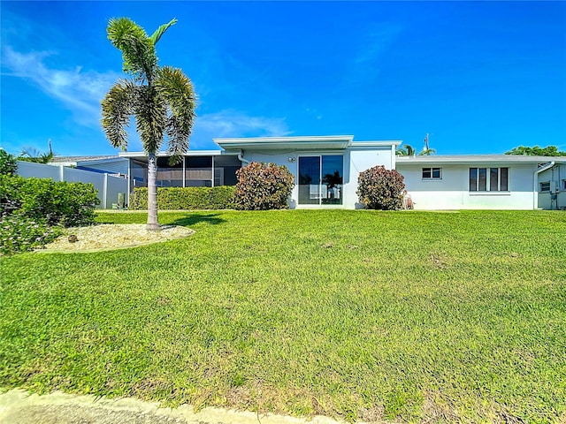 rear view of property with a yard