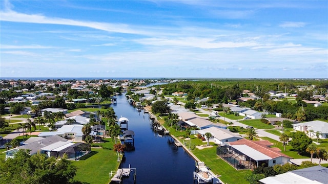 birds eye view of property with a water view and a residential view