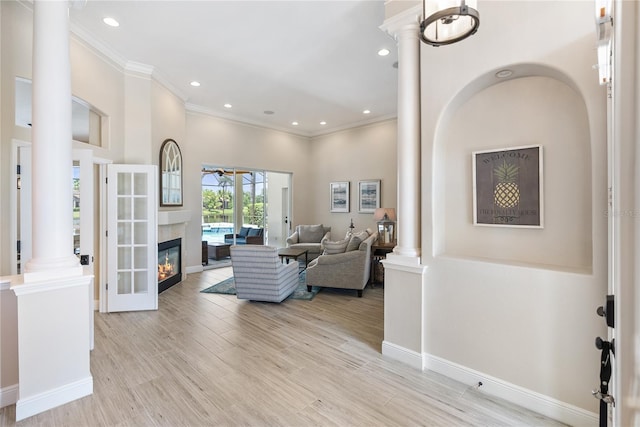 living room with light hardwood / wood-style floors and ornamental molding