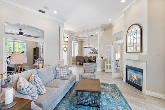 living room with ceiling fan, french doors, crown molding, and light hardwood / wood-style flooring