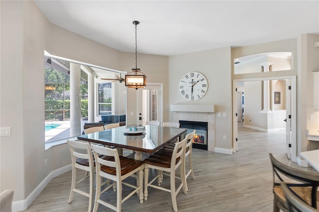 dining room with decorative columns and light hardwood / wood-style flooring