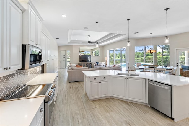 kitchen featuring sink, white cabinetry, an island with sink, and appliances with stainless steel finishes