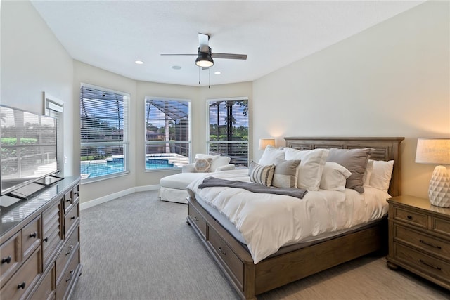 bedroom with light carpet, multiple windows, and ceiling fan