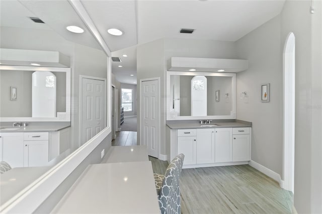 bathroom featuring hardwood / wood-style flooring and vanity