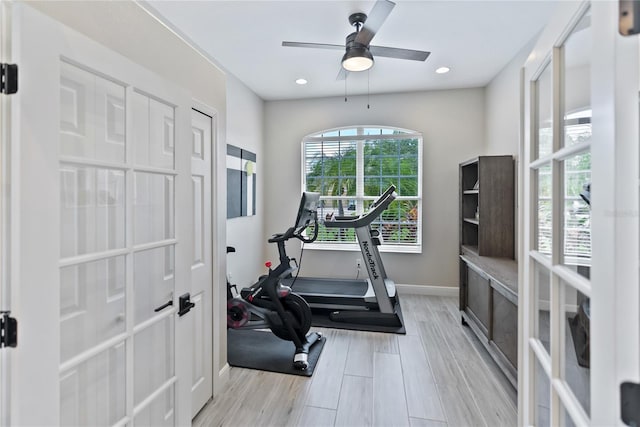 workout area featuring ceiling fan and light wood-type flooring