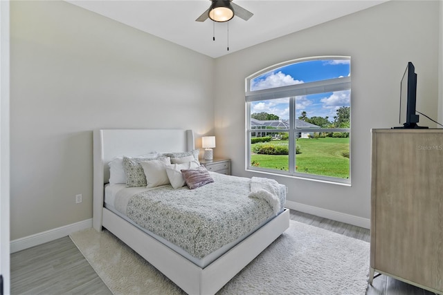 bedroom with hardwood / wood-style floors and ceiling fan