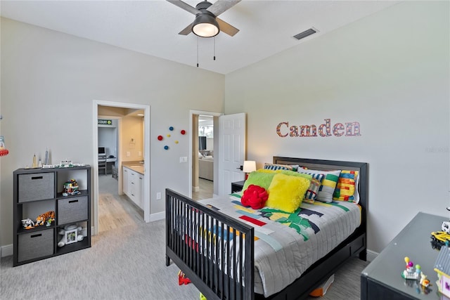 carpeted bedroom featuring ceiling fan and ensuite bath